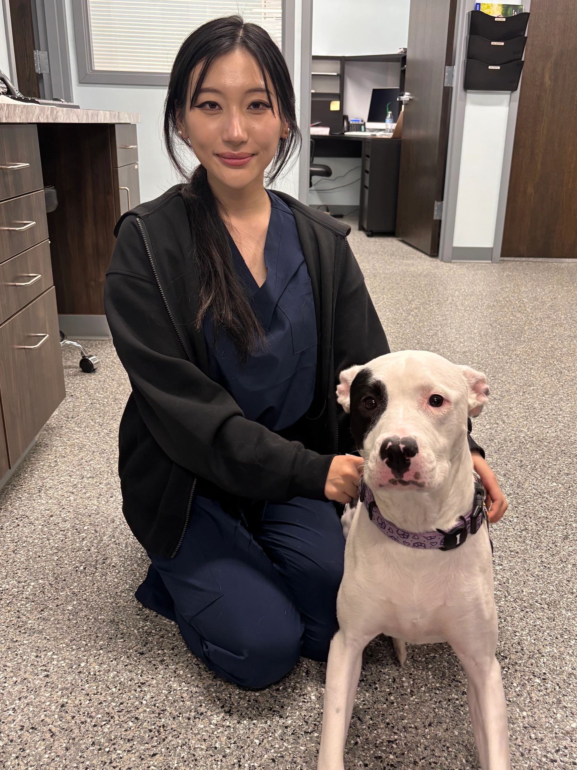 Dr. Cindy Zhao with a white dog